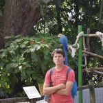 Mike posing with one of the parrots.